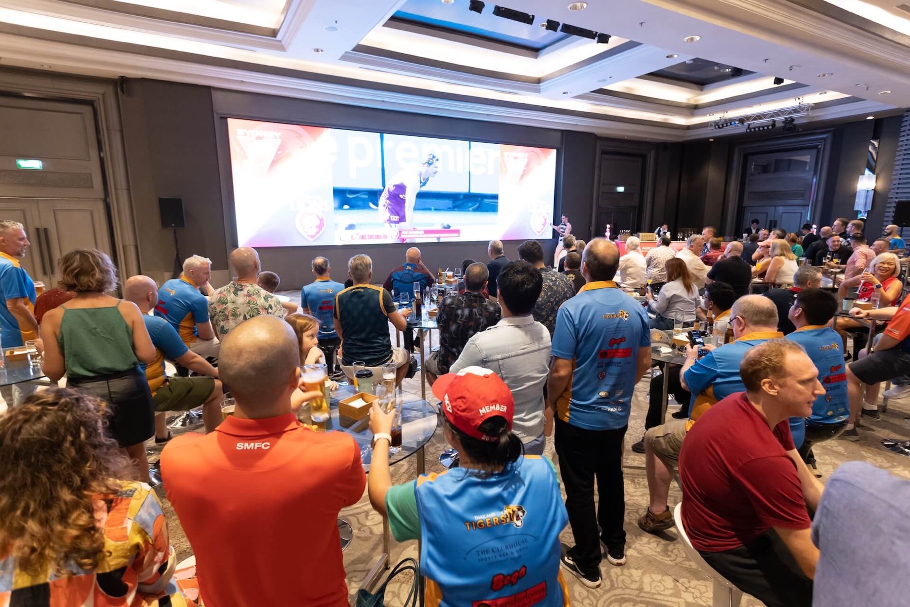 A seated audience watching a large screen at a Chamber event